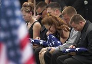 Beverly A. Crow, center, sits with unidentified family members during the funeral for her husband, Missouri Army National Guard Sgt. Robert Wayne Crow, in Liberty, Mo., in this July 19, 2010, file photo. Sgt. Crow, 42, of Kansas City, Mo., died July 10 in Paktika, Afghanistan, of wounds suffered when insurgents attacked his vehicle with an improvised explosive device. He was a combat engineer with the 203rd Engineer Battalion headquartered in Joplin, Mo.
