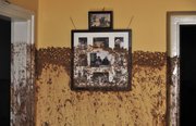Family photos on a wall Thursday show the height of the sludge after a flood of toxic mud broke into a home in the village of Kolontar, Hungary. Monday’s flooding was caused by the rupture of a red sludge reservoir at a metals works in western Hungary and has affected seven towns near the Ajkai, 100 miles southwest of Budapest.