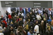 In this Dec, 21, 2009 file photo, travelers wait to enter terminals at the San Francisco International Airport. Forecasts for higher fares and crowded planes suggest travelers should book their 2010 holiday plans now. Online travel website Expedia says fares will stay below last year’s peak levels for the next few weeks before climbing.
