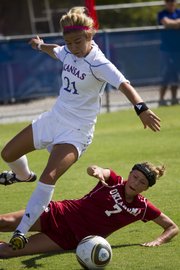 Oklahoma forward Jordan White (7) tackles Kansas University forward Emily Cressy. KU suffered a 3-1 loss to OU Sunday at the Jayhawk Soccer Complex.