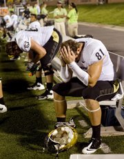 Colorado’s Luke Walters, right, and Ethan Adkins wait dejectedly on the sideline during the final seconds of CU’s 26-0 loss to Missouri last Saturday in Columbia, Mo. Unlike Nebraska, Colorado is having a lousy farewell tour of the Big 12.