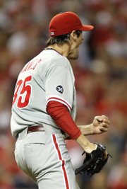 Philadelphia Phillies starting pitcher Cole Hamels celebrates after striking out the Cincinnati Reds’ Scott Rolen to end Game 3 of their National League division series on Sunday in Cincinnati. Hamel’s complete-game shutout gave the Phillies a 3-0 sweep of the Reds.