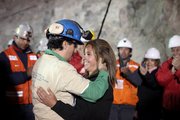 Miner Raul Bustos embraces an unidentified woman Wednesday after after being rescued from the collapsed San Jose gold and copper mine where he had been trapped with 32 other miners for over two months near Copiapo, Chile, in this photo released by the Chilean government.