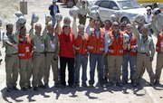 Chile’s Mining Minister Laurence Golborne, fifth from left, poses for photos Thursday with the team of mine rescuers that took part in the rescue operation of the 33 trapped miners, at the San Jose mine near Copiapo, Chile.