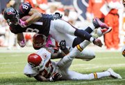Houston tight end Owen Daniels (81) flies over Kansas City Chiefs defenders Donald Washington (27) and Jovan Belcher after a fourth-quarter catch.