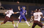 Kansas quarterback Jordan Webb throws under pressure from Texas A&M defensive lineman Ben Bass (90) during the second quarter Saturday, Oct. 23, 2010 at Kivisto Field.
