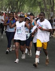 66-year-old Orah Bessit, foreground left, participates in a road race Sept. 16 in Johannesburg. Bessit, who grows her own vegetables, walks and runs, recognizes that staying healthy requires sacrifices, so she has given up hamburgers and switched from white bread to whole-grain. A growing urban middle class is defying the image of Africa as poor, underfed and under-medicated. And with the comforts of middle-class life, afflictions familiar in the West are making inroads here too: obesity, diabetes, lung cancer, strokes, heart disease.