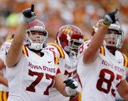 Iowa State players Alex Alvarez, left, and Jake Williams celebrate a play during the first half of ISU’s 28-21 victory Saturday over Texas in Austin, Texas.