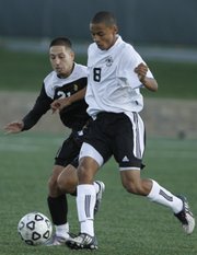 Free State high senior midfielder Preston Newsome (8) works for control against Topeka High forward Luis Blanco. The Firebirds fell, 1-0 in double overtime, on Tuesday at FSHS.