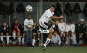 Free State junior forward Jacob Walter heads the ball upfield during the first half against Topeka High Wednesday, Oct. 13, 2010 at Free State High School.