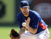 Texas Rangers pitcher Cliff Lee fields a hit during baseball pitching drills on Sunday in Arlington, Texas. Lee will start Game 1 of the World Series for the Rangers tonight against the Giants in San Francisco.