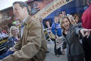 Republican gubernatorial candidate Sam Brownback and Rep. Lynn Jenkins greet a crowd of supporters as they exit the GOP candidate bus in Lawrence on Wednesday. The Kansas Republican Party’s bus tour stopped by congressional candidate Kevin Yoder's Lawrence headquarters, 123 W. Eighth St.