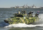 In this photo released by the U.S. Navy, sailors assigned to Riverine Group 1 conduct maneuvers aboard Riverine Command Boat (Experimental) (RCB-X) at Naval Station Norfolk, Va., on Friday. The RCB-X is powered by an alternative fuel blend of 50 percent algae-based and 50 percent NATO F-76 fuels to reduce total energy consumption on naval ships.