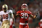 North Carolina State’s Brandan Bishop (30) reacts after breaking up a Florida State pass during the first half Thursday in Raleigh, N.C. Florida State’s Beau Reliford is in the back.