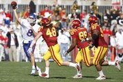 Kansas quarterback Quinn Mecham throws as he is chased by Iowa State defenders Jacob Lattimer (48), Bailey Johnson (85) and Stephen Ruempolhamer (97) during the second quarter Saturday, Oct. 30, 2010 at Jack Trice Stadium.