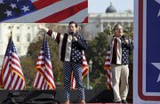 Comedians Stephen Colbert, left, and Jon Stewart perform Saturday during their Rally to Restore Sanity and/or Fear on the National Mall in Washington. The “sanity” rally blending laughs and political activism drew thousands to the mall with Stewart and Colbert casting themselves as the unlikely maestros of moderation and civility in polarized times.