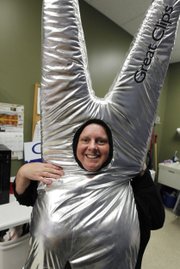 At the Great Clips hair salon, Jenny Bagwell shows her scissors outfit, which she wears about 12 hours a week to attract potential customers in Maple Grove, Minn.