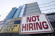 A sign turning away potential job-seekers is seen Nov. 4 outside of a construction site in New Orleans. Employers added the most jobs in five months in October, with the education and health care sectors leading the way.