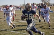 Ethan Scott (28) scrambles for a first half touchdown during the Veritas Eagles' state championship game against St. MaryÕs Academy, Saturday, Nov. 6, 2010.