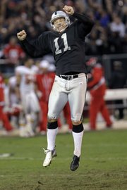 Raiders kicker Sebastian Janikowski celebrates his winning field goal in a 23-20 OT victory over the Chiefs on Sunday in Oakland, Calif.