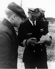 Steve Woelk smiles on Dec. 23, 1969, as a Navy officer checks his name at the South Korean side of the Bridge of No Return, ending his 11 months of captivity in North Korea.
