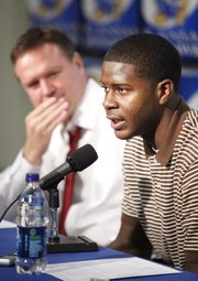 Kansas freshman guard Josh Selby talks with media members along side head coach Bill Self during a news conference announcing that Selby will be released to play following a nine-game suspension.