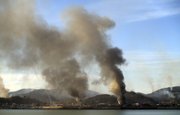 Smoke rises Tuesday from South Korea’s Yeonpyeong island near the border against North Korea. North Korea fired artillery barrages onto the South Korean island near their disputed border Tuesday, setting buildings alight and prompting South Korea to return fire and scramble fighter jets.