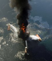 The Deepwater Horizon oil rig burns after an explosion in the Gulf of Mexico in this April 21 photo. A new study from the presidential oil spill commission describes the behind-the-scenes, excruciating tension and mistakes behind the effort to cap the well.