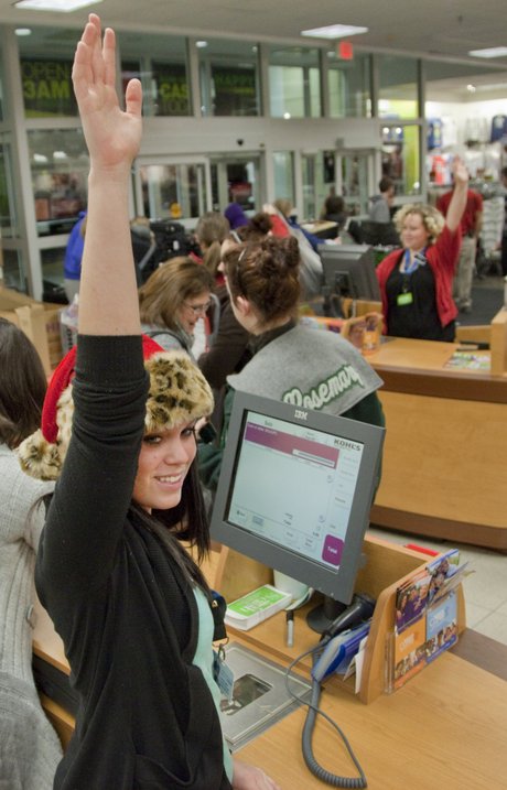 Hannah Bassett, a Kohl's employee, waves to let the next customer in ...