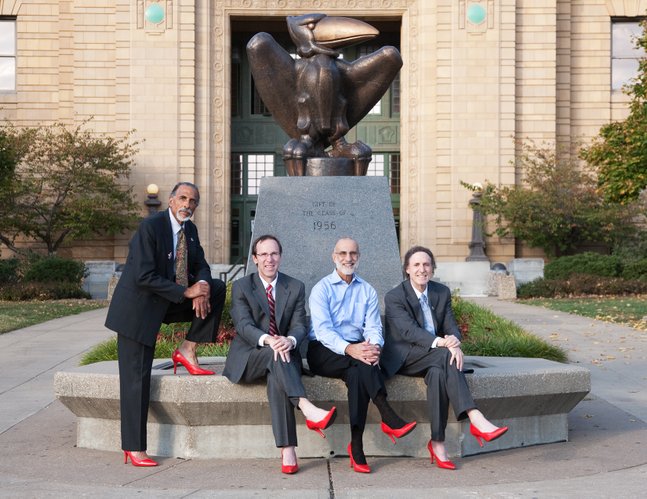 From left, Shade Little, husband of Kansas University Chancellor Bernadette Gray-Little; Danny Anderson, dean of the School of Liberal Arts and Sciences at KU; John Nalbandian, professor of public administration at KU; and Rick Ginsberg, dean of the school of education, are pictured in front Strong Hall. The photo is featured in the 2011 Red Shoe calendar that raises money for The Willow Domestic Violence Center.