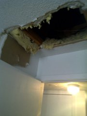 A hole gapes in the ceiling of an apartment in the 1100 block of Louisiana Street. Five people were arrested early Saturday morning for burglaries in the area.