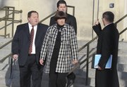 Former University of Kansas athletic department consultant, Thomas Ray Blubaugh, and his wife Charlette Blubaugh, left and center, leave the U.S. Federal Courthouse, in Wichita, Kan., on Wednesday, Dec. 8, 2010, after being arraigned on a charge of conspiring to commit wire fraud. Prosecutors say the couple, along with others, are charged with stealing athletic tickets and scalping them for cash to ticket brokers and third parties outside the university totally $5 million.