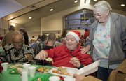 Bob Taylor, Mary Louise Taylor and Grace Oshel visit over the Christmas dinner at First United Methodist Church on Saturday.