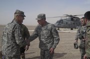 Gen. David Petraeus, second left, top U.S. and NATO commander in Afghanistan, is greeted by Brig. Gen. Skip Davis at an Italian base in Farah, Afghanistan, on Saturday.