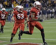 North Carolina State wide receiver Jarvis Williams (5) celebrates his 7-yard touchdown catch with center Camden Wentz (53). N.C. State defeated West Virginia, 23,-7, in the Champs Sports Bowl on Tuesday in Orlando, Fla.