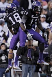 TCU cornerback Travaras Battle (18) and wide receiver Antoine Hicks celebrate a play against Wisconsin. TCU won, 21-19, in Saturday’s Rose Bowl in Pasadena, Calif.