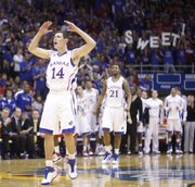 Kansas guard Tyrel Reed celebrates a dunk by teammate Josh Selby against Miami (Ohio) University during the first half, Sunday, Jan. 2, 2011 at Allen Fieldhouse.