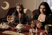 Romanian witch Mihaela Minca, right, speaks Wednesday during an interview with The Associated Press, as her daughter and apprentice Casanndra, left, looks on, in Mogosoaia, Romania. Trouble is brewing for Romania’s witches, whose toil is being taxed for the first time despite their threats of putting curses on the government.