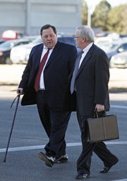 Former University of Kansas athletic department consultant, Thomas Ray Blubaugh, left, and his attorney Steve Robison arrive at the U.S. Federal Courthouse, in Wichita, Kan., on Friday, Jan. 28, 2011, to plead guilty on a charge of conspiring to commit wire fraud. Prosecutors say he, along with others, are charged with stealing athletic tickets and scalping them for cash to ticket brokers and third parties outside the university totally $5 million.