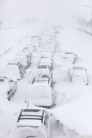 Hundreds of cars are seen stranded Wednesday on Lake Shore Drive in Chicago. A winter blizzard of historic proportions wobbled an otherwise snow-tough Chicago, stranding hundreds of drivers for up to 12 hours overnight on the city’s showcase lakeshore thoroughfare and giving many city schoolchildren their first-ever snow day.