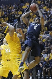 Pitt’s Gilbert Brown (5) shoots over West Virginia’s Kevin Jones. Pittsburgh won, 71-66, Monday, Feb. 7, 2011 in Morgantown, W.Va.