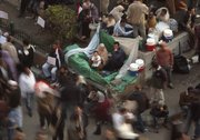 Egyptian anti-Mubarak protesters take part in a demonstration at Tahrir square in Cairo on Tuesday. Protesters appear to have settled in for a long standoff, turning Tahrir Square into a makeshift village with tens of thousands coming every day.