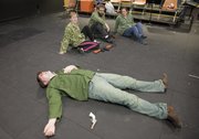 From left actors Jason Daniel, Gretchen Gier, Chris Nelson and Kari Jackson perform the skit "Sarge" at the Lawrence Arts Center during a rehearsal for the comedy show "Loaded for Bear." The show opens this Friday at the Lawrence Arts Center&squot;s black box theater.