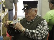 Tom Smith, of Springfield, Mo., checks off his list of train parts as he dressed the part of a train conductor.
