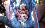 Alyssa Lynn Leming gives a big yawn in her rocker on Monday in her Lecompton home. Baby Alyssa's birth on Friday, Feb. 18, 2011 happened in an elevator at Lawrence Memorial Hospital after her mother, Crystal Leming, went into labor unexpectedly.