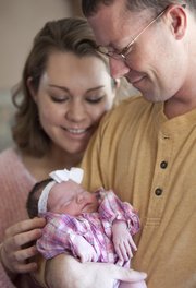 Patrick and Crystal Leming are pictured with their infant daughter, Alyssa, in their Lecompton home on Monday. Alyssa was born before her mother could make it to the delivery room at Lawrence Memorial Hospital, and arrived in the elevator.