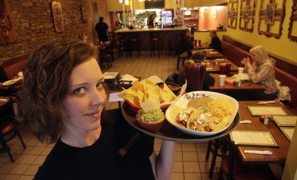 La Parrilla, at 814 Massachusetts has been name best Latin Food in downtown Lawrence as Lauren McCoy, manager and server serves up Fish Tacos and chips, a crowd favorite.