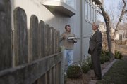 Robert Coffman, with AirTight Energy Audits, talks to homeowner Tony Schmidt about his home's energy loss and ways to fix the problem. The audit, which was done March 3, is one way Lawrence residents can participate in the Take Charge Challenge.