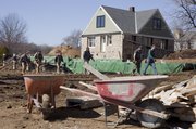 Kansas University architecture students in Studio 804 are currently building what will showcase the latest in green technology. The foundation of the new structure is seen in the middle of the photograph behind Studio 804 students. Part of the Center for Design Research, the project is located near properties on the old Chamney farm on KU’s West Campus near Bob Billings Parkway and Westbrooke Street.