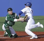 Kansas runner Jimmy Waters, (7) right, is thrown out at home against Eastern Michigan Friday, March 11, 2011. It was the second time in three innings that Waters had reached base only to be thrown out at home.